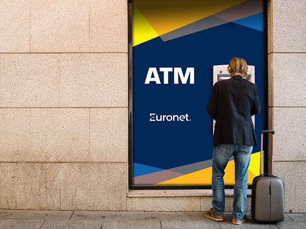 A photo of a man using a Ͽ¼ ATM